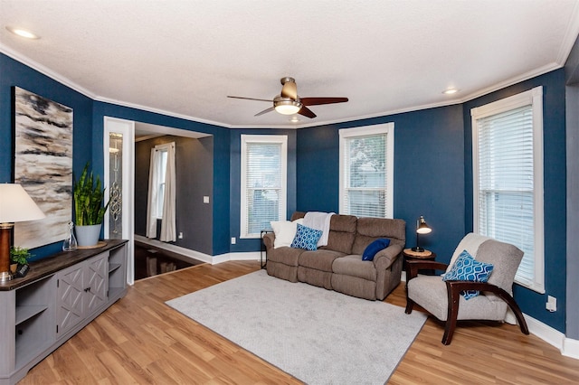 1807 11th St, Des Moines, IA 50314 - living room featuring crown molding, light wood-style floors, baseboards, a ceiling fan, and recessed lighting