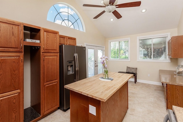 1807 11th St, Des Moines, IA 50314 - kitchen featuring stainless steel fridge with ice dispenser, butcher block countertops, brown cabinets, lofted ceiling, and a ceiling fan