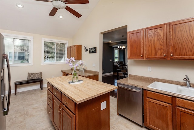 1807 11th St, Des Moines, IA 50314 - kitchen with dishwasher, a sink, butcher block counters, ceiling fan, and brown cabinetry