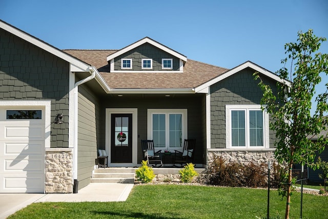 16427 N Valley Dr, Urbandale, IA 50323 - view of front of property with stone siding, a porch, a front yard, and a shingled roof