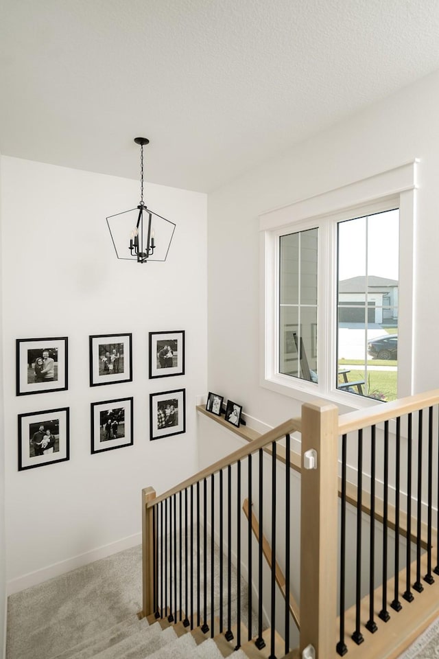 16427 N Valley Dr, Urbandale, IA 50323 - stairs featuring a chandelier and carpet flooring