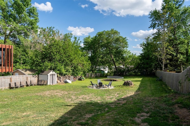 208 Mckinley Ave, Des Moines, IA 50315 - view of yard with a storage shed, a fire pit, an outdoor structure, and a trampoline