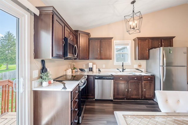 208 Mckinley Ave, Des Moines, IA 50315 - kitchen featuring appliances with stainless steel finishes, a sink, lofted ceiling, dark wood-style flooring, and light countertops