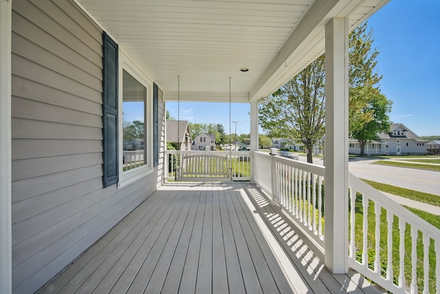 311 E Main St, Panora, IA 50216 - wooden deck with covered porch and a residential view