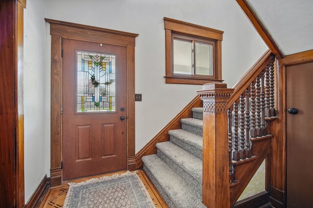 311 E Main St, Panora, IA 50216 - foyer featuring stairs, baseboards, and wood finished floors