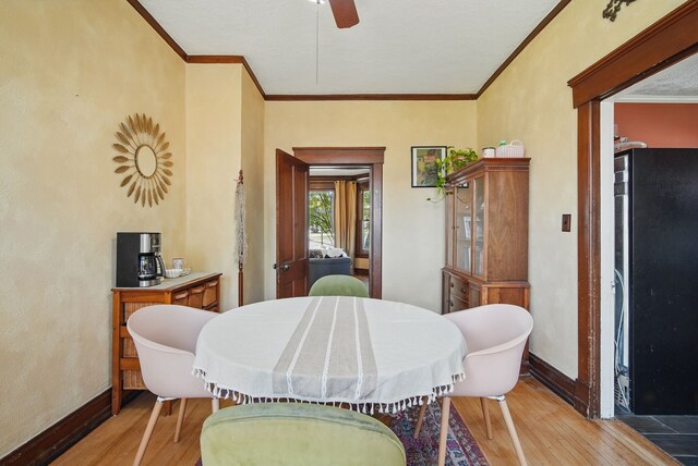 311 E Main St, Panora, IA 50216 - dining area featuring light wood-style flooring, crown molding, baseboards, and ceiling fan