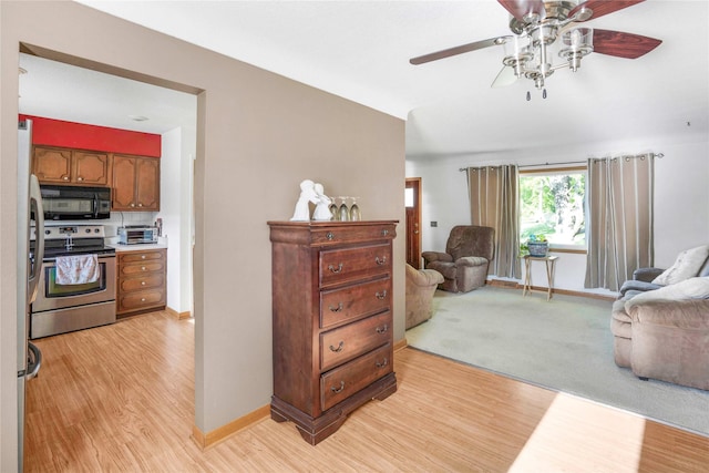 2106 62nd St, Des Moines, IA 50322 - living area with light wood-style flooring, ceiling fan, and baseboards