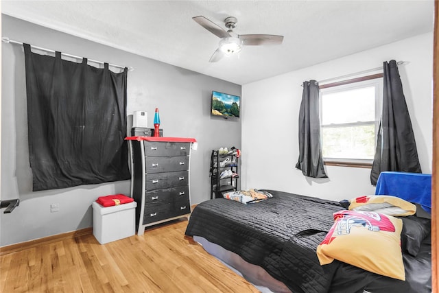 2106 62nd St, Des Moines, IA 50322 - bedroom featuring wood finished floors, ceiling fan, and baseboards