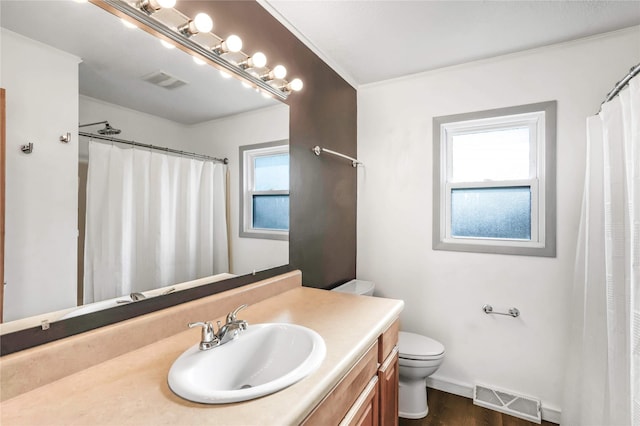 2106 62nd St, Des Moines, IA 50322 - bathroom with toilet, vanity, baseboards, wood finished floors, and curtained shower