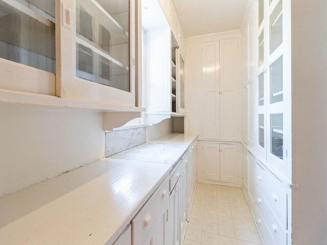 1070 37th St, Des Moines, IA 50311 - kitchen with white cabinetry, glass insert cabinets, and light countertops