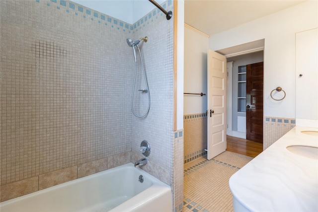 1070 37th St, Des Moines, IA 50311 - bathroom featuring tile patterned floors, bathtub / shower combination, a sink, and tile walls