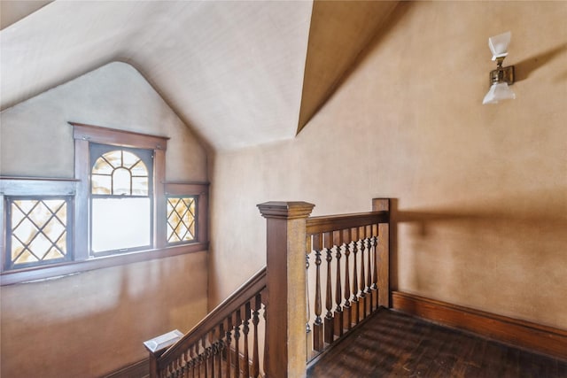 1070 37th St, Des Moines, IA 50311 - stairs featuring hardwood / wood-style flooring, vaulted ceiling, and baseboards