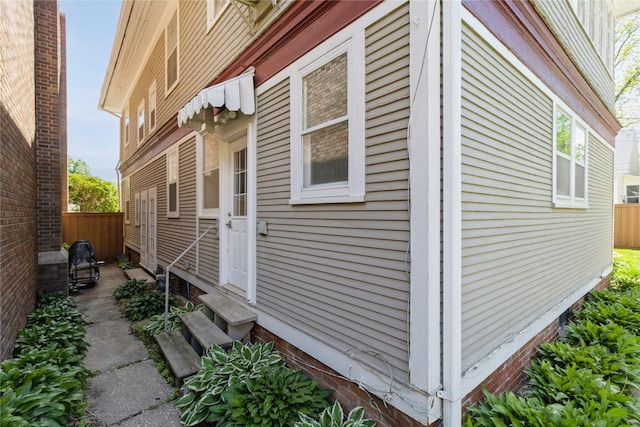 1070 37th St, Des Moines, IA 50311 - view of property exterior featuring entry steps and fence