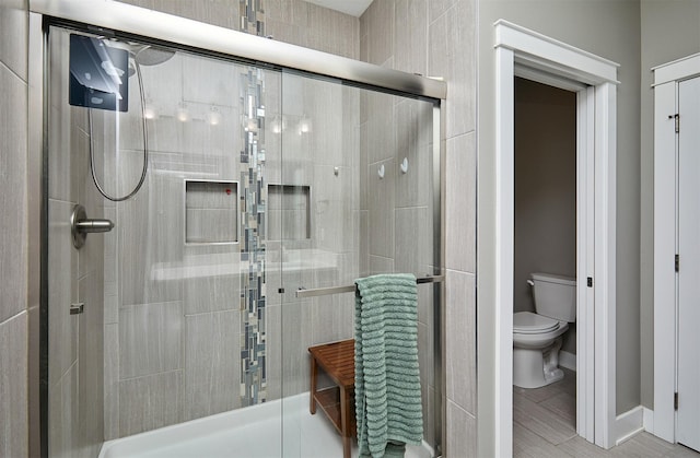 1412 NE Aspen Ct, Grimes, IA 50111 - full bathroom featuring a shower stall, toilet, and baseboards