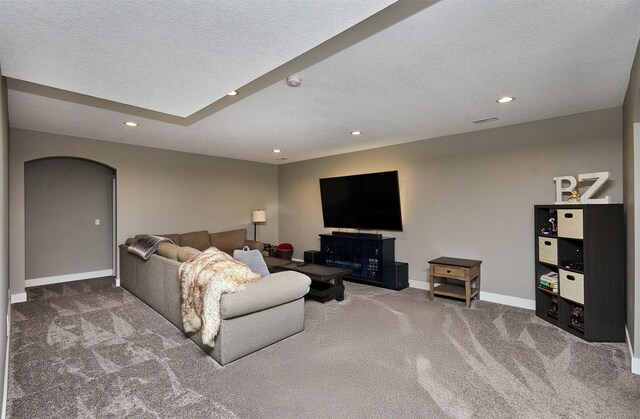 1412 NE Aspen Ct, Grimes, IA 50111 - living room featuring carpet, recessed lighting, baseboards, arched walkways, and a textured ceiling