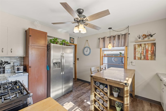 kitchen featuring stainless steel fridge with ice dispenser, dark wood-style flooring, decorative backsplash, and baseboards
