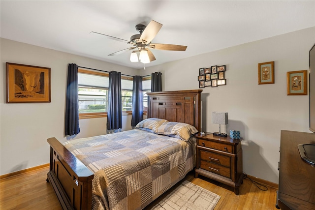 bedroom with baseboards, light wood-type flooring, and ceiling fan