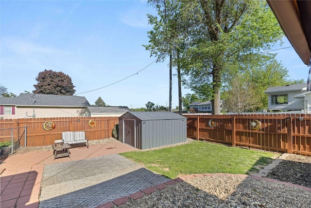 view of yard featuring a patio area, a storage shed, and an outbuilding