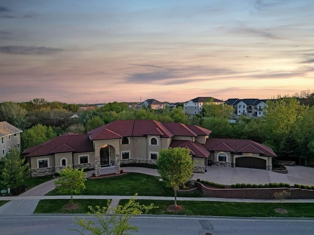 4408 Cochrane Pkwy, Ames, IA 50014 - view of front facade with curved driveway, a front yard, stone siding, and stucco siding
