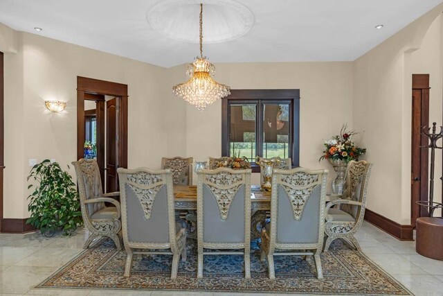 4408 Cochrane Pkwy, Ames, IA 50014 - dining area with baseboards, tile patterned flooring, and a chandelier
