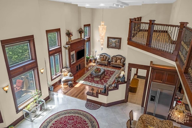4408 Cochrane Pkwy, Ames, IA 50014 - living room with light tile patterned floors, baseboards, and a towering ceiling
