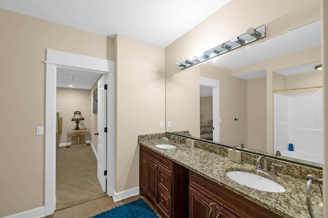 4408 Cochrane Pkwy, Ames, IA 50014 - bathroom with ensuite bathroom, double vanity, baseboards, and tile patterned floors