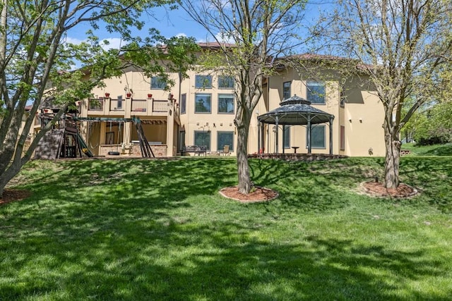 4408 Cochrane Pkwy, Ames, IA 50014 - back of house featuring stucco siding, a gazebo, a lawn, and stairs