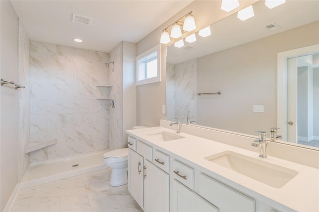 17151 Plum Dr, Urbandale, IA 50323 - bathroom with toilet, marble look tiles, double vanity, a tile shower, and recessed lighting