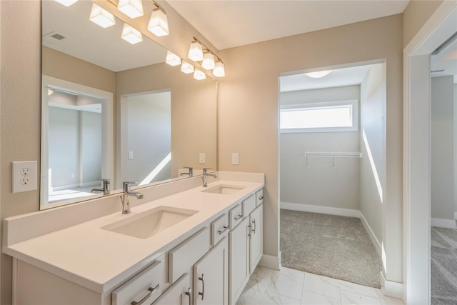17151 Plum Dr, Urbandale, IA 50323 - full bath featuring double vanity, baseboards, and marble finish floors
