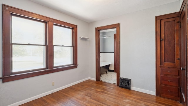 unfurnished bedroom featuring baseboards and wood finished floors