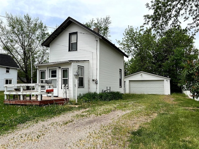 1013 E 10th St N, Newton, IA 50208 - view of front of home featuring a detached garage, an outdoor structure, a chimney, and a deck