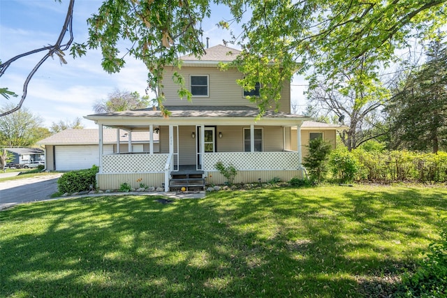630 E Clay St, Osceola, IA 50213 - view of front of property featuring covered porch, a front lawn, and a detached garage