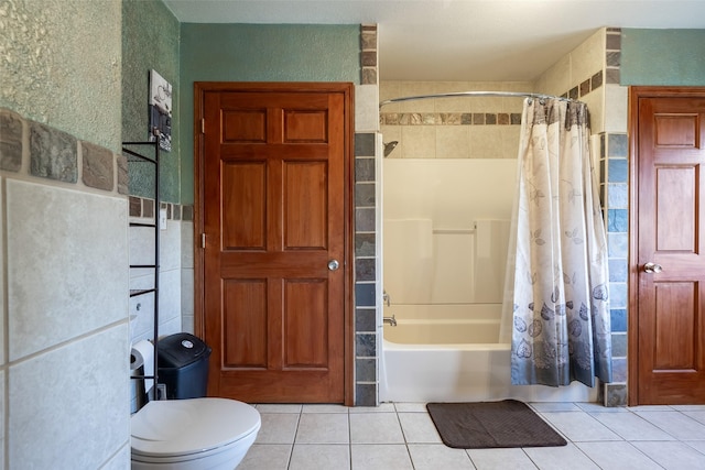 630 E Clay St, Osceola, IA 50213 - full bath featuring shower / bath combo with shower curtain, tile patterned floors, and toilet