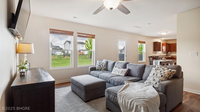 1508 E Euclid Ave, Indianola, IA 50125 - living area featuring dark wood-style flooring, a ceiling fan, and baseboards