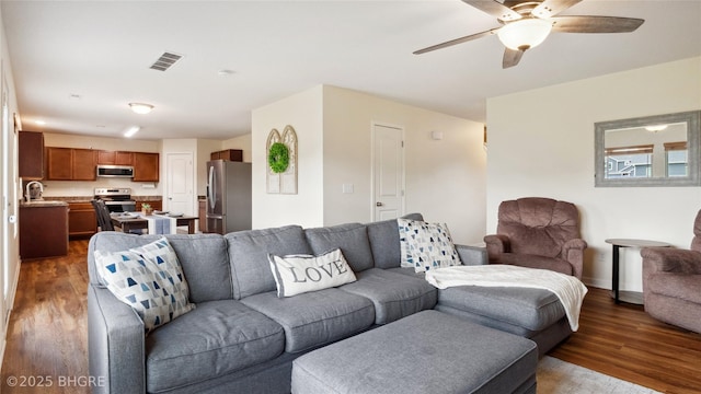 1508 E Euclid Ave, Indianola, IA 50125 - living area with dark wood-type flooring, ceiling fan, and baseboards