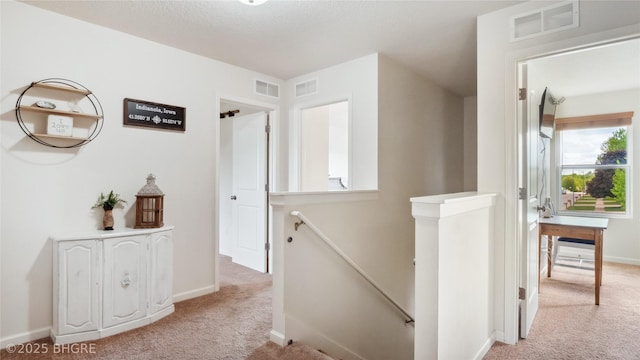 1508 E Euclid Ave, Indianola, IA 50125 - hallway featuring an upstairs landing, light colored carpet, and baseboards