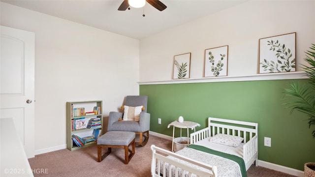 1508 E Euclid Ave, Indianola, IA 50125 - carpeted bedroom featuring a crib, baseboards, and a ceiling fan