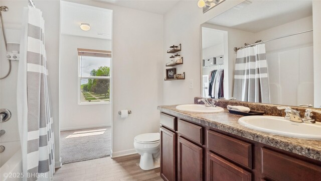 1508 E Euclid Ave, Indianola, IA 50125 - full bath with toilet, wood finished floors, double vanity, and baseboards