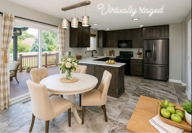 5928 NW 50th St, Johnston, IA 50131 - kitchen with black appliances, dark brown cabinetry, healthy amount of natural light, and light countertops