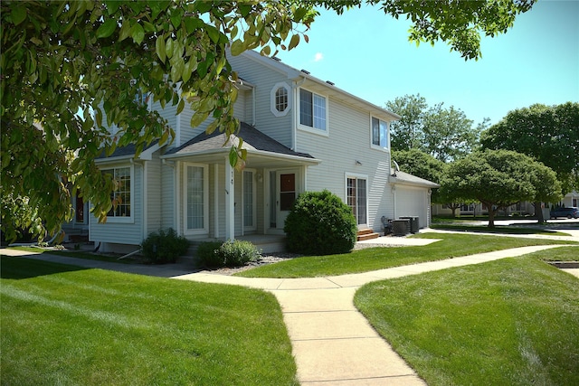 555 SE Laurel St Unit 14, Waukee, IA 50263 - view of front facade with covered porch, a front lawn, an attached garage, and central AC