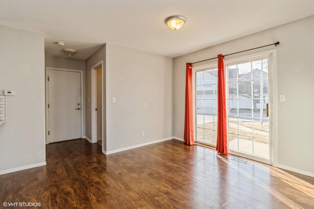 555 SE Laurel St Unit 14, Waukee, IA 50263 - spare room with dark wood-type flooring and baseboards