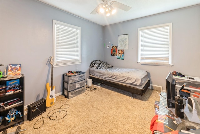 carpeted bedroom featuring baseboards and ceiling fan