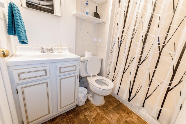 bathroom featuring toilet, vanity, and a shower with curtain