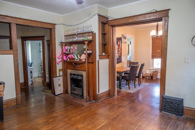 1143 27th St, Des Moines, IA 50311 - living room with wood-type flooring, ornamental molding, a fireplace, a chandelier, and heating unit