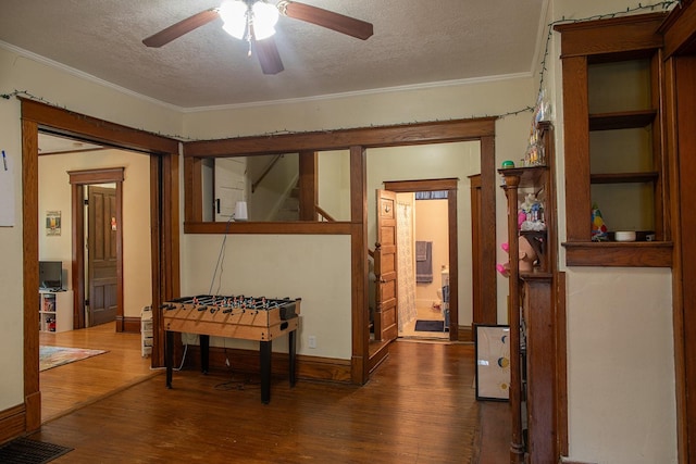 1143 27th St, Des Moines, IA 50311 - hall featuring wood finished floors, ornamental molding, a textured ceiling, and stairway