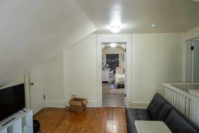 1143 27th St, Des Moines, IA 50311 - additional living space featuring wood-type flooring, vaulted ceiling, and baseboards