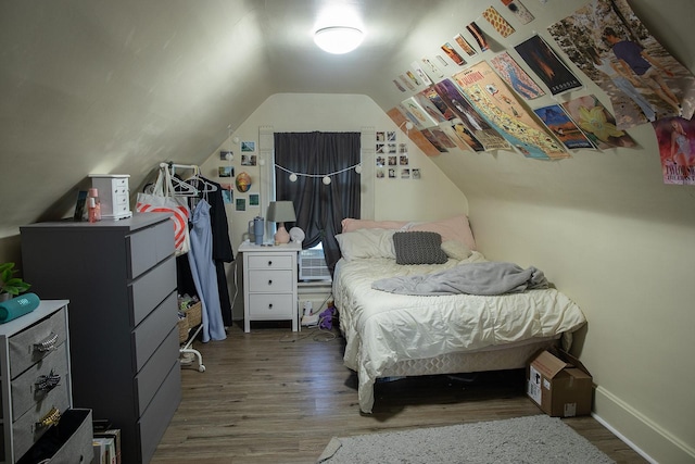 1143 27th St, Des Moines, IA 50311 - bedroom featuring wood finished floors, lofted ceiling, and baseboards
