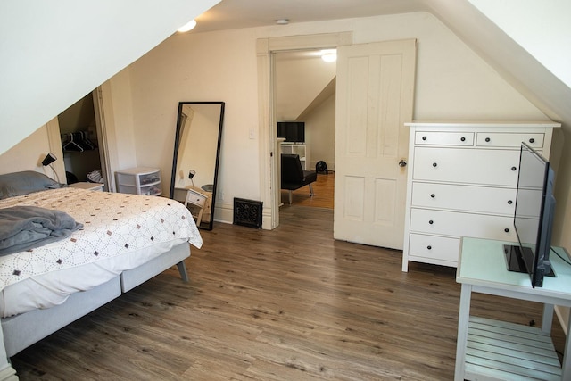 1143 27th St, Des Moines, IA 50311 - bedroom with vaulted ceiling and wood finished floors