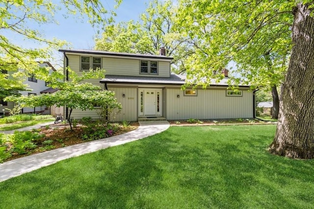 3312 Oakland St, Ames, IA 50014 - view of front of home with a chimney and a front yard