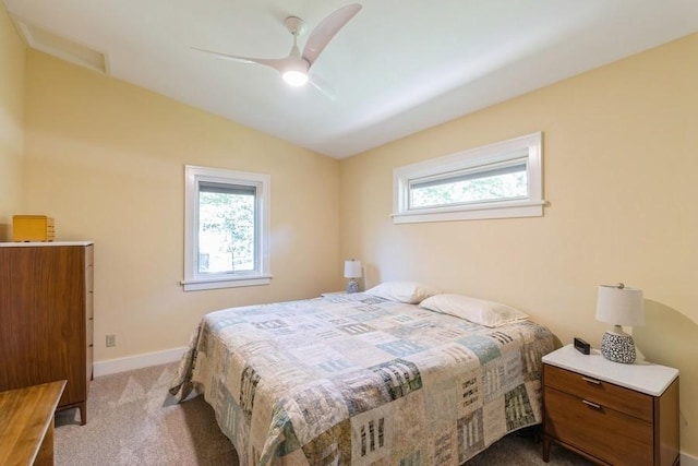 3312 Oakland St, Ames, IA 50014 - carpeted bedroom with multiple windows, vaulted ceiling, baseboards, and a ceiling fan